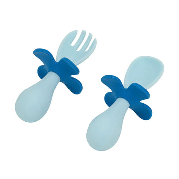 Blue and light blue baby utensils on a white background.