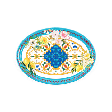 An oval tray printed with flowers and lemons on a yellow and blue pattern.