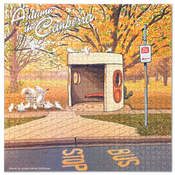 Jigsaw puzzle box titled 'Autumn in Canberra' on a pink background.