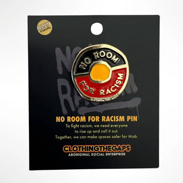 A irregular shaped round pin in the shape of the Aboriginal flag and the text 'No Room for Racism' around the inside is attached to a black card with product information.