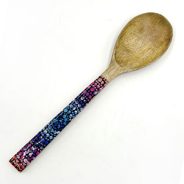 A wooden serving spoon printed with artwork by Olivia Wilson on the front.