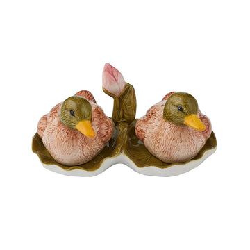 A pair of salt and pepper shakers shaped like ceramic ducks sitting down.