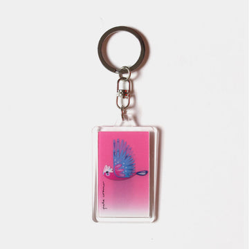 A rectangle keyring with a moving image of a galah flying against a pink background.