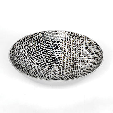 A stainless steel bowl printed with artwork by Paulina Puruntatameri on the inside.