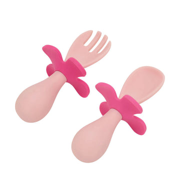 Pink and magenta silicone utensils on a white background.