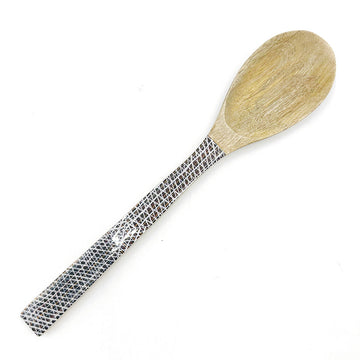 A wooden serving spoon printed with artwork by Paulina Puruntatameri on the front.