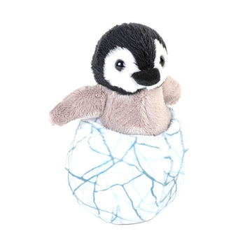 Plush penguin toy inside a cracked egg toy on a white background.