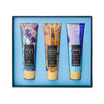 An open square box with three hand cream tubes inside each printed with different colourful artwork.