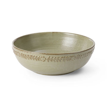 Green ceramic bowl with decorative pattern on a white background