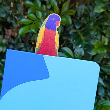 Wooden bookmark with a colorful bird design on a white background.