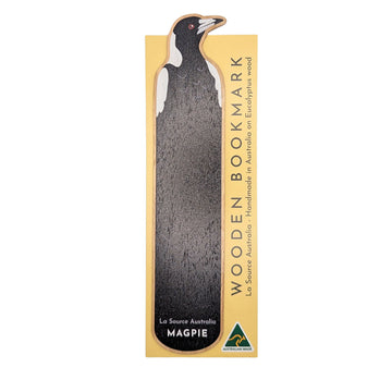 Wooden bookmark with magpie design attached to packaging on a white background.