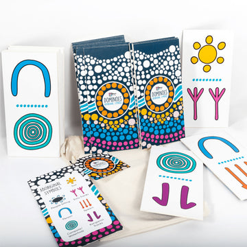 Box of Aboriginal Symbols Dominoes game with colorful design on a white background.
