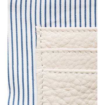 A cream coin purse with a zip opening at the top.