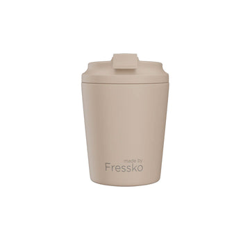 Beige tumbler with a lid on a white background, branded 'made by Fressko'.