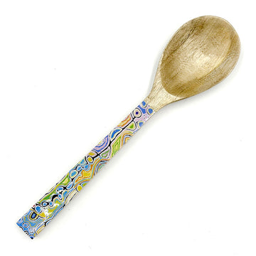 A wooden serving spoon printed with artwork by Judy Watson on the front.