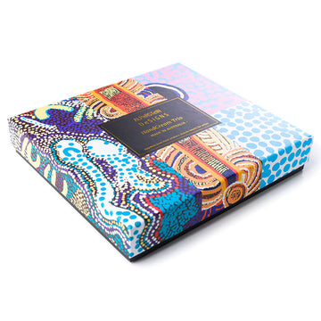 An open square box with three hand cream tubes inside each printed with different colourful artwork.