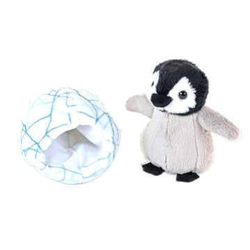Plush penguin toy inside a cracked egg toy on a white background.