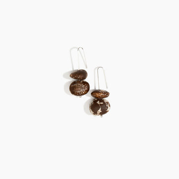 Pair of earrings with brown spherical resin beads on a white background.