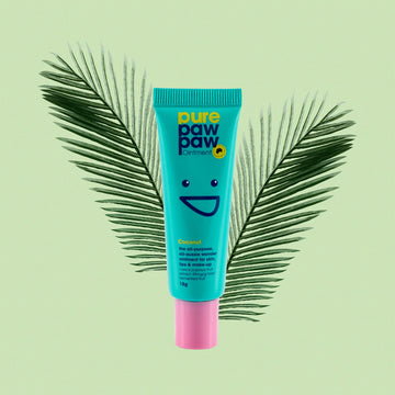 Blue tube of pure paw paw with a smiley face design on a light green background with palm leaves.