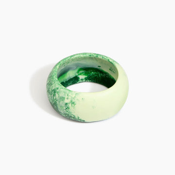 Green and white marbled bangle on a white background.