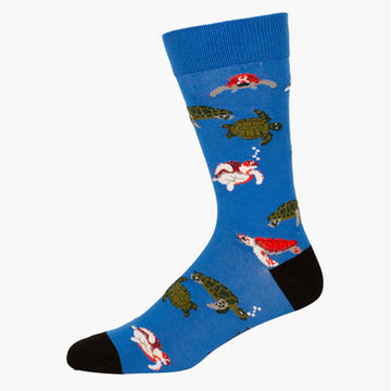 A blue sock with red and green sea turtles illustrated on it.