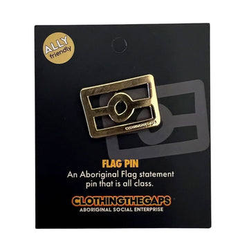 A gold enamel in shaped like the outline of the Aboriginal flag attached to a black card.