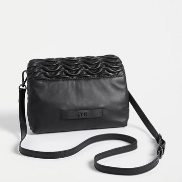 Front view of a rectangle cross body bag with an embossed wave pattern across the bag.