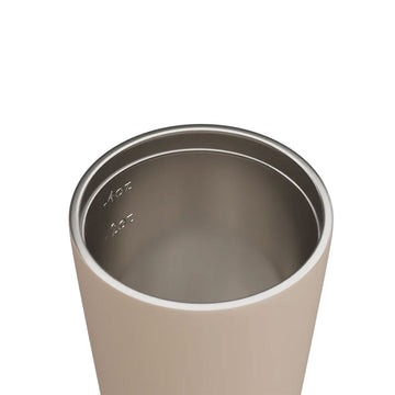 Beige tumbler with a lid on a white background, branded 'made by Fressko'.
