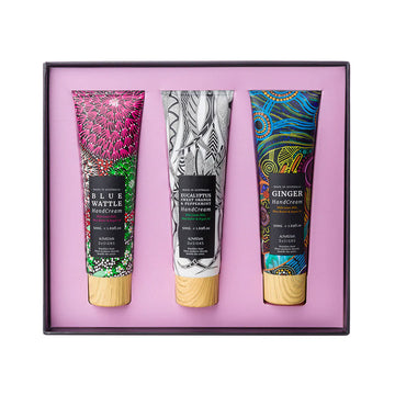 An open square box with three hand cream tubes inside each printed with different colourful artwork.