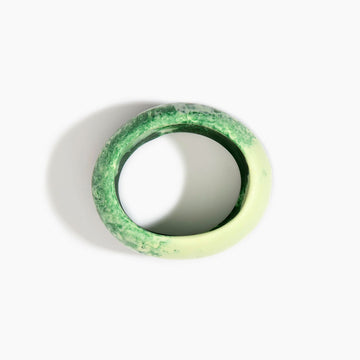 Green and white marbled bangle on a white background.