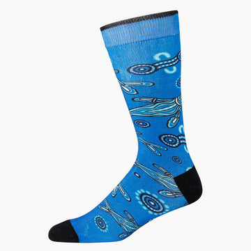 A blue sock with a black heel and toe and illustrated with seals.