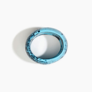 Blue and black marbled bangle on a white background.