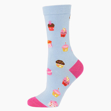 A light blue sock with a pink heel and toe and illustrated with cupcakes.