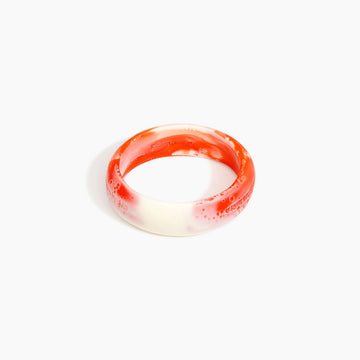 Bangle with red and white gradient on a white background.