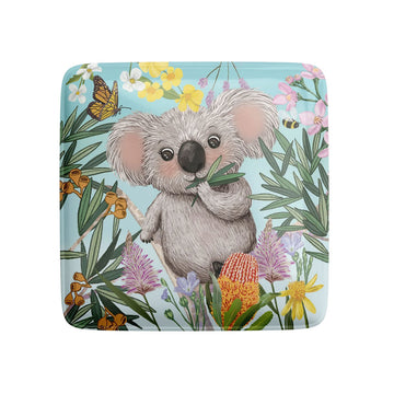 Coaster with a koala illustration surrounded by flowers and leaves on a blue background.