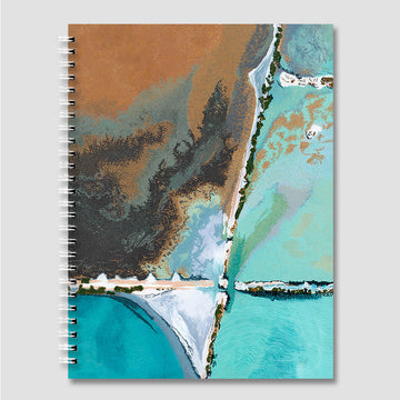Notebook with a beachscape design on the cover.