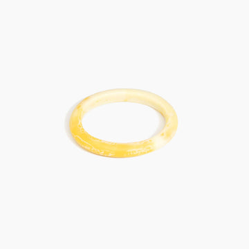 Yellow bangle on a white background.