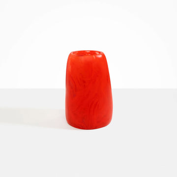 A tall resin vase in red.
