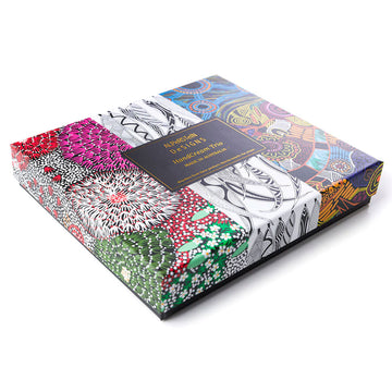 An open square box with three hand cream tubes inside each printed with different colourful artwork.