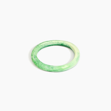 Green bangle on a white background.