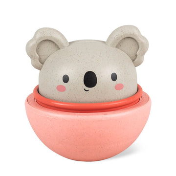 A round koala toy sitting in a pink cup.