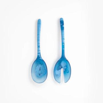 Two blue resin salad servers on a white background.
