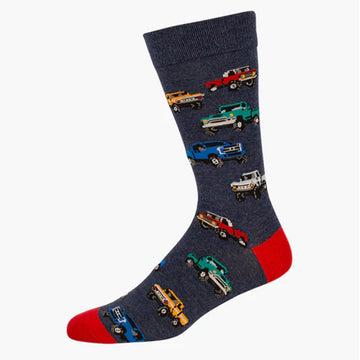 A denim blue sock with a red heel and toe and illustrations of colourful trucks.