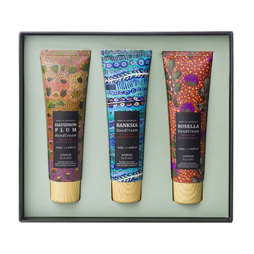 An open square box with three hand cream tubes inside each printed with different colourful artwork.