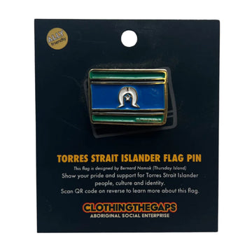 An enamel pin shaped and printed with the Torres Strait Island Flag attached to a card with product information.