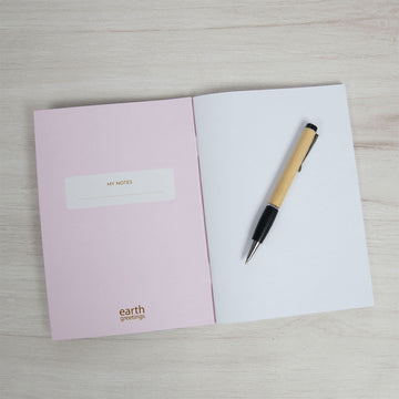 Front cover of a notebook illustrated with pink, yellow and orange wildflowers and a product information sleeve around the middle.