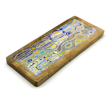 A wooden tray printed with artwork by Judy Watson on the inside.