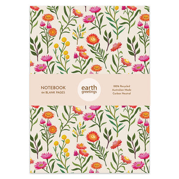 Front cover of a notebook illustrated with pink, yellow and orange wildflowers and a product information sleeve around the middle.