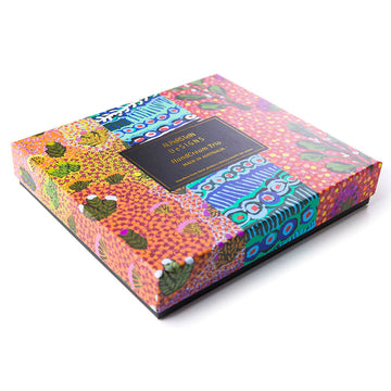 An open square box with three hand cream tubes inside each printed with different colourful artwork.