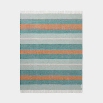 Striped throw with blue and orange stripes on a light gray background.